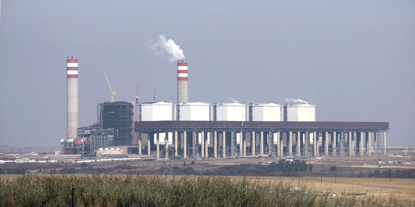 Kusile power station in Mpumalanga under construction, cooling towers and boiler house against open veld.